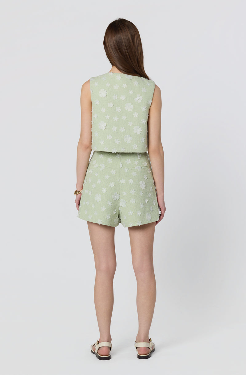 Light green sleeveless top and matching shorts with white floral print.