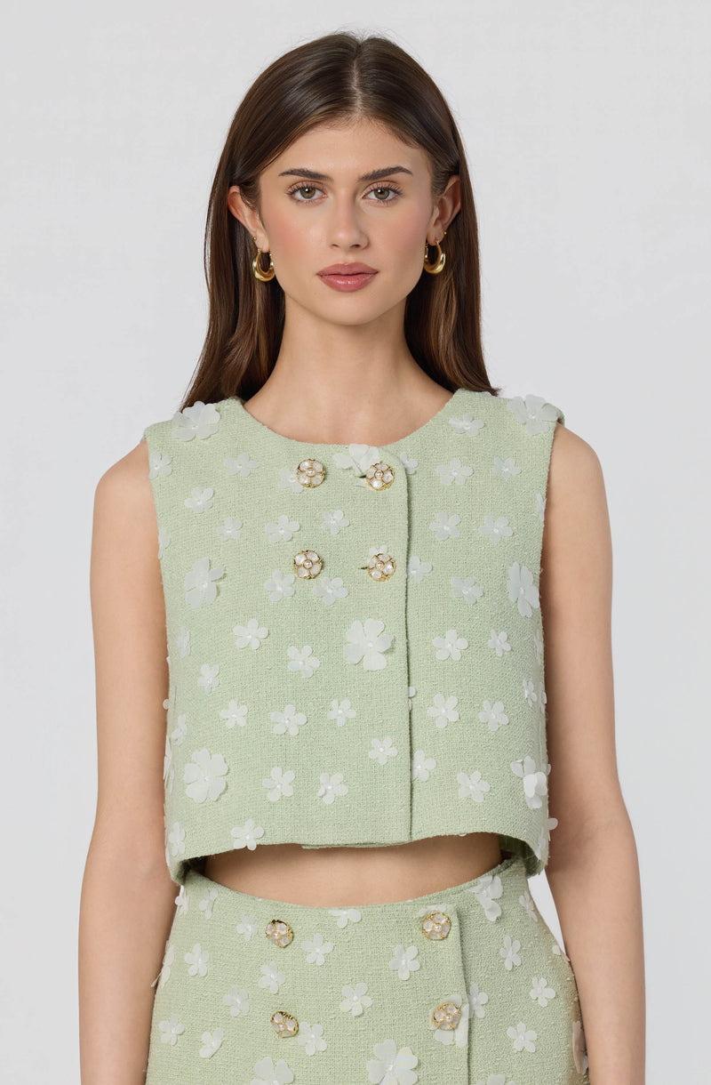 Light green sleeveless cropped top and matching skirt with white floral appliqué details.