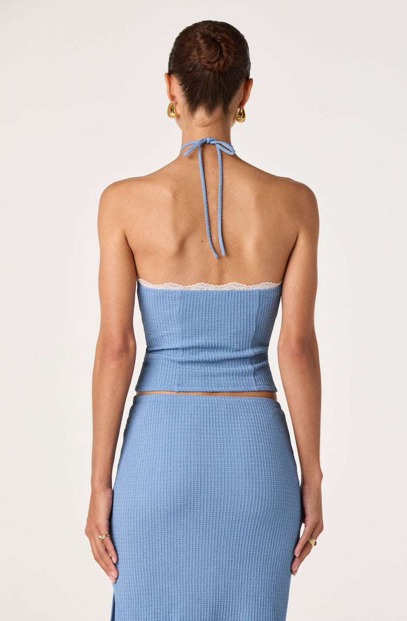 Light blue strapless top with white lace trim and matching high-waisted skirt, tied at the neck.
