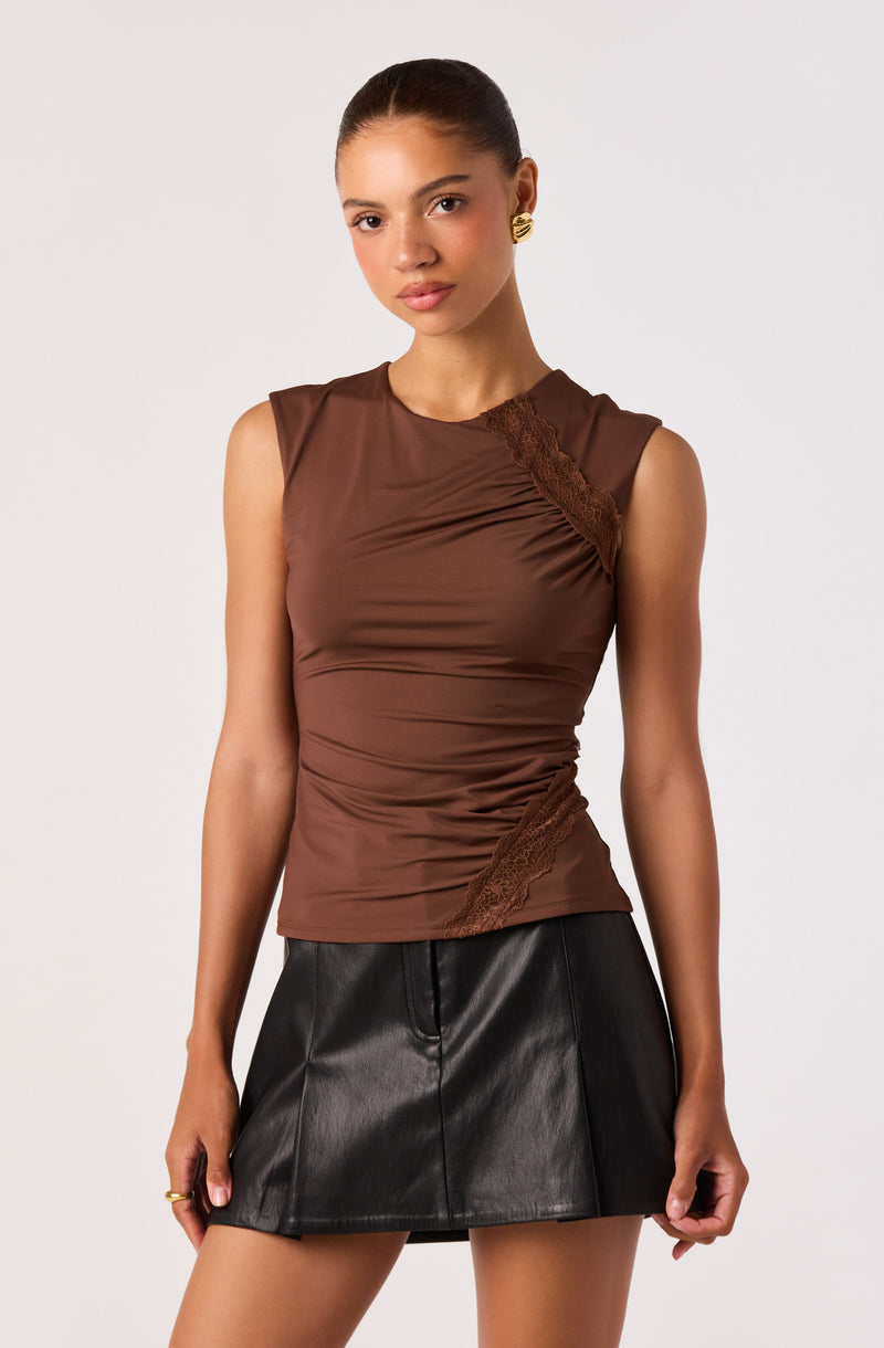 Sleeveless brown top with lace detail and black leather mini skirt.