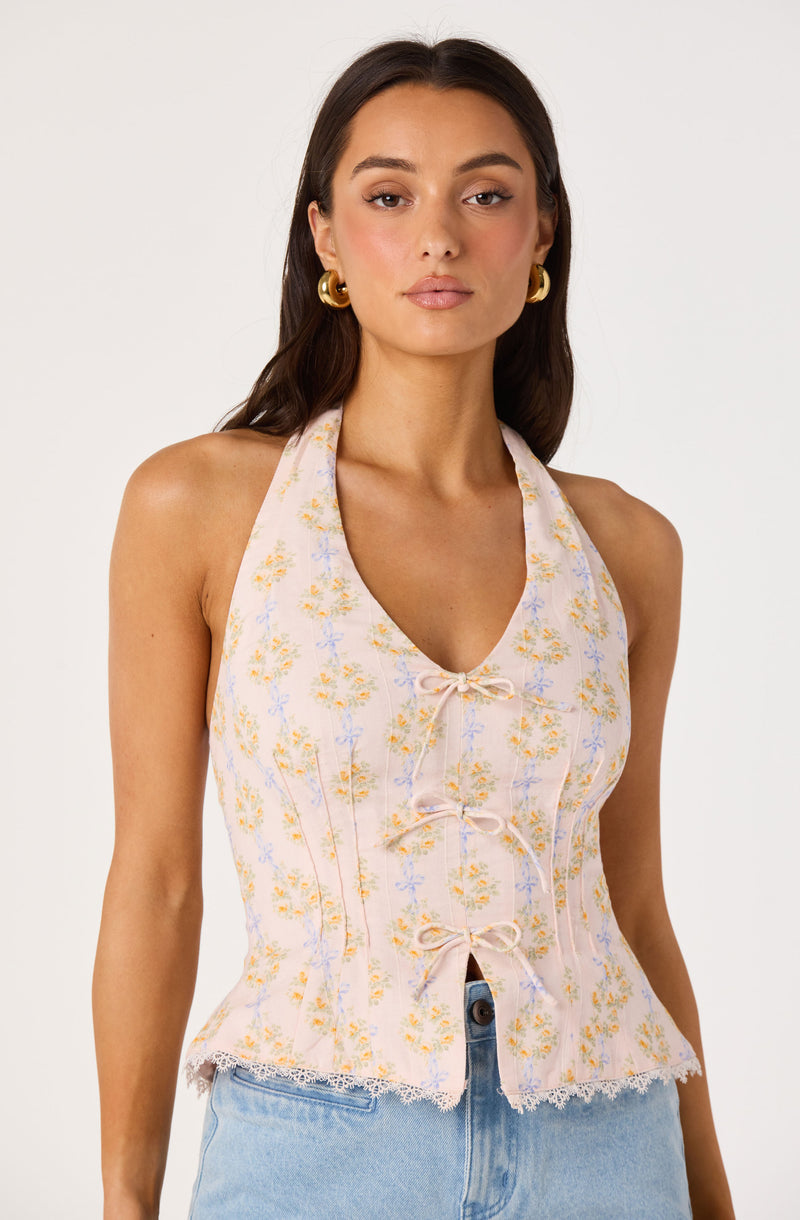 Sleeveless floral top with bow ties and a frayed hem.