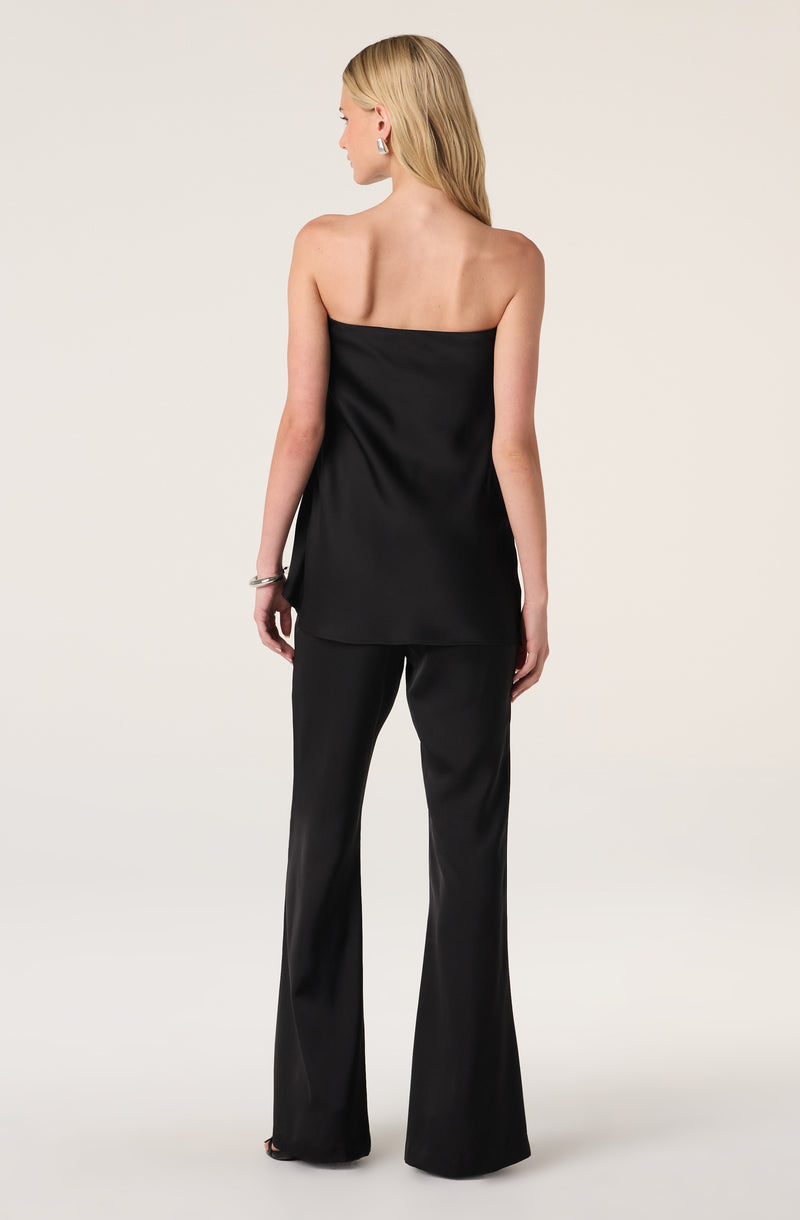 Woman wearing a black strapless top and black wide-leg satin pants.