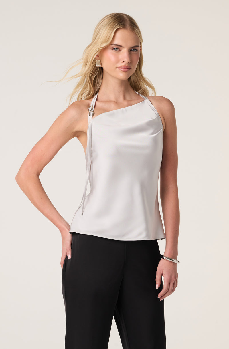 Women wearing white satin sleeveless top with adjustable shoulder straps and black pants.