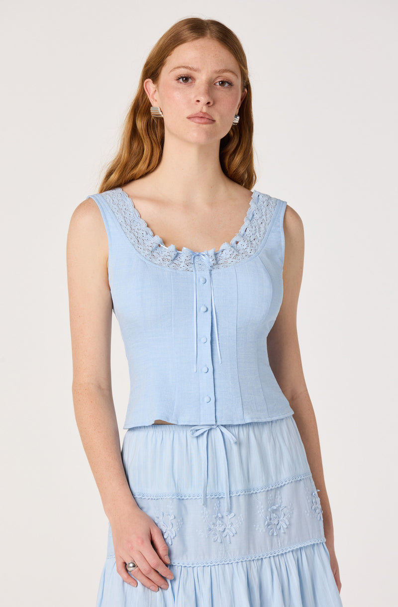 Light blue sleeveless top with lace trim and buttons, paired with a matching flowy skirt.