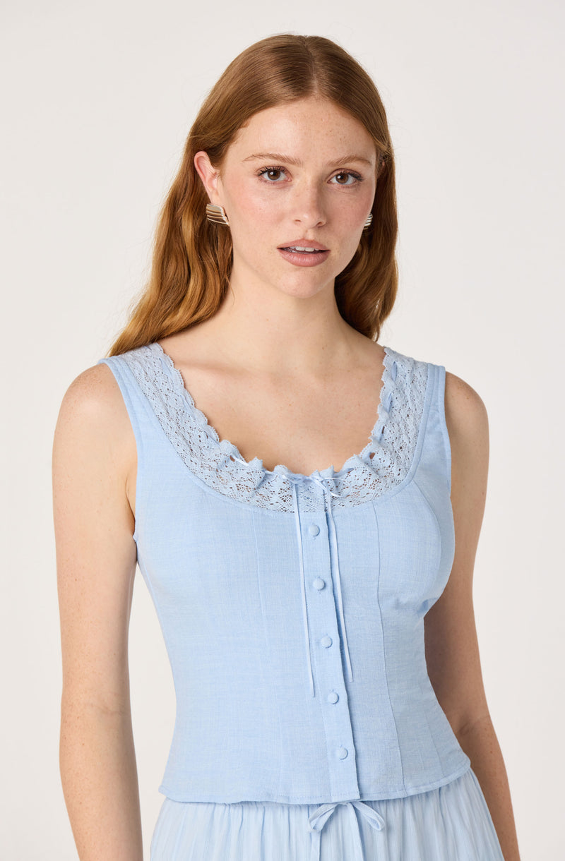 Light blue sleeveless top with lace trim and buttons down the front.