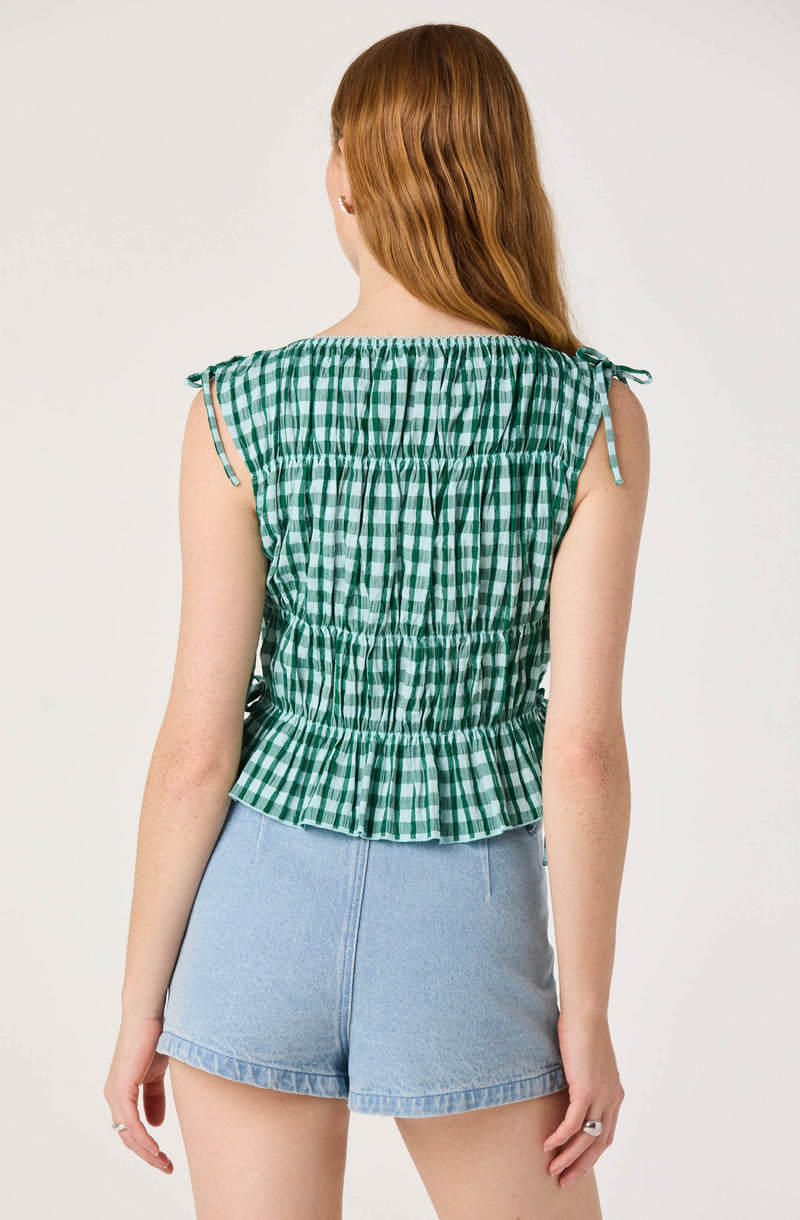 Green and white checkered sleeveless top with tie details on shoulders.