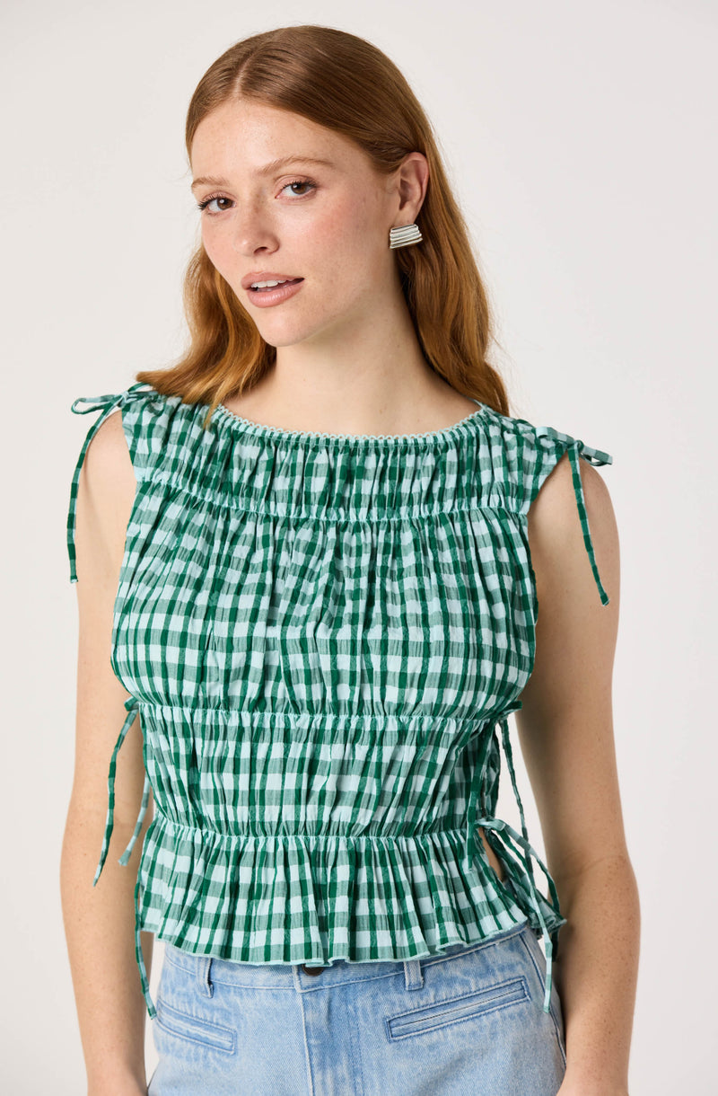 Green and white checkered sleeveless top with tie straps and ruffled hem.