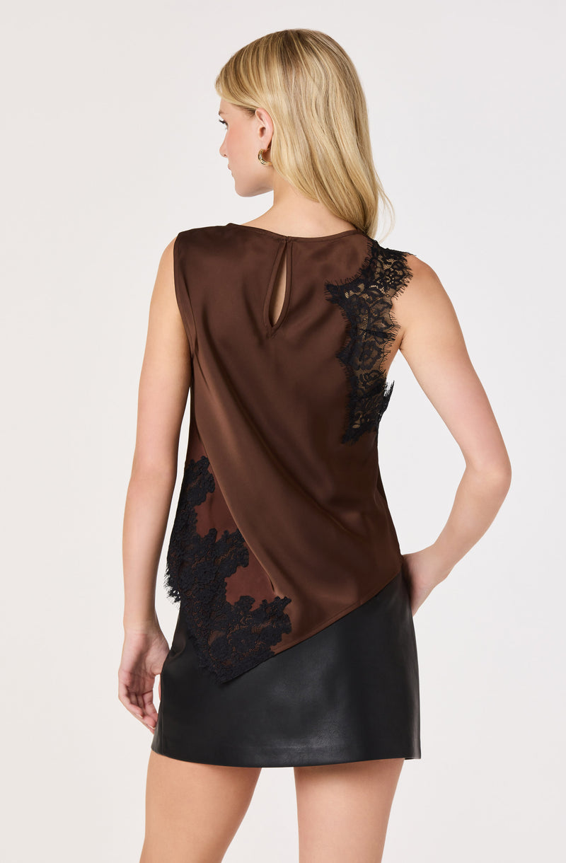 Brown satin sleeveless top with black lace details, paired with a black leather skirt.