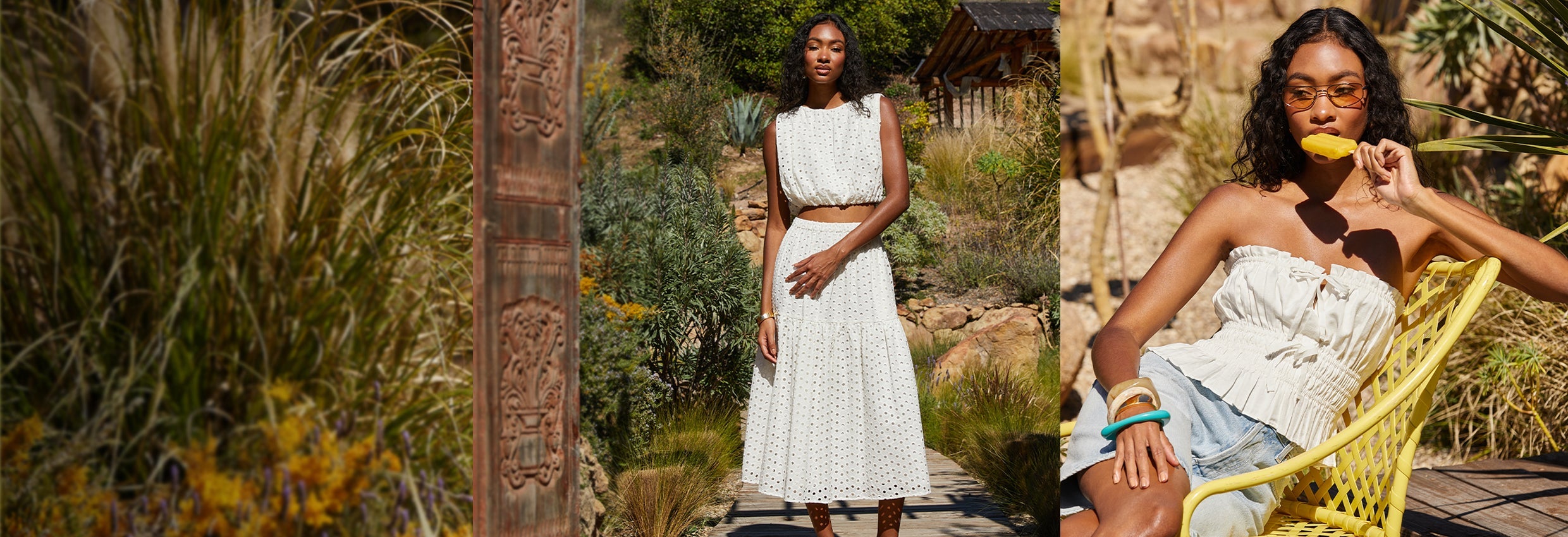 Model wearing a white eyelet two-piece set standing outdoors in a desert garden, and sitting in a yellow chair wearing a white ruched top and denim shorts while eating a popsicle.

