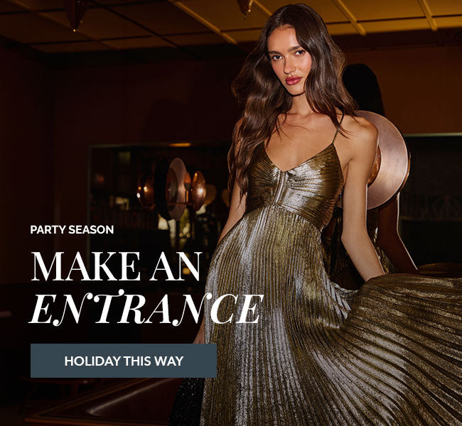 Woman in metallic gold, pleated, spaghetti strap dress.