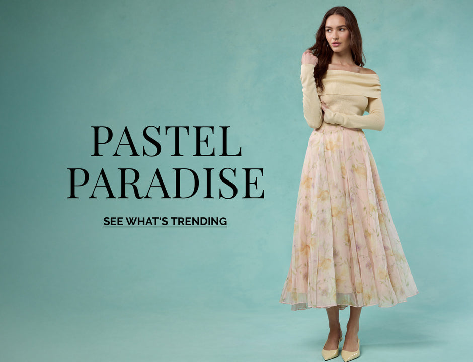 Woman wearing an off-the-shoulder cream sweater and a long pastel floral skirt.