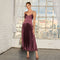 Model wears a sleeveless, color-blocked red and purple pleated maxi dress.