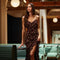 Woman in a dark floral slip dress with spaghetti straps and ruffle hem.