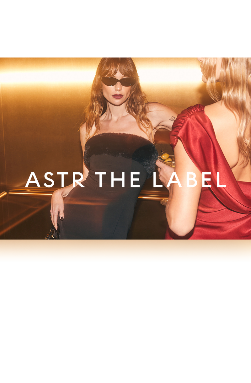 Two women wearing glamorous dresses, one in a strapless black gown and sunglasses, and the other in a red satin dress with puffed sleeves.